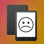 An Amazon Kindle with a sad face drawn on the screen