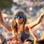 A woman dances on a friend's shoulders at the Glastonbury Festival held at Worthy Farm, in Pilton, Somerset on June 29 near Glastonbury, England. The festival, founded in 1970, has grown into one of the largest outdoor green field festivals in the world.(Photo by Matt Cardy/Getty Images)