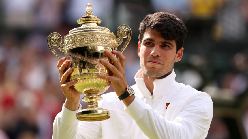 Carlos Alcaraz holds the Wimbledon Men's trophy aloft after his 2024 success.