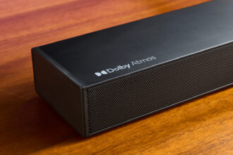 Ultimea Nova S50 soundbar on a wooden surface in front of a TV