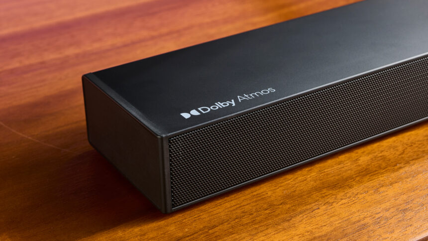 Ultimea Nova S50 soundbar on a wooden surface in front of a TV