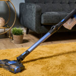 The Shark Anti Hair Wrap Cordless Vacuum cleaning a rug