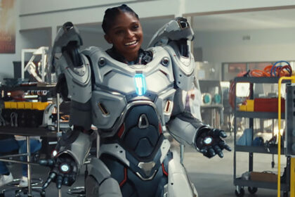 A smiling Riri Williams wearing her white iron armor suit in Ironheart