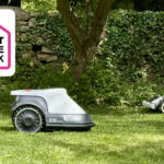 Two robot lawn mowers on some grass, with Smart Home Week logo