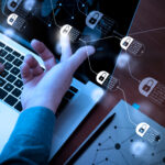 Hands working on laptops touching diagram of chain and encrypted blocks