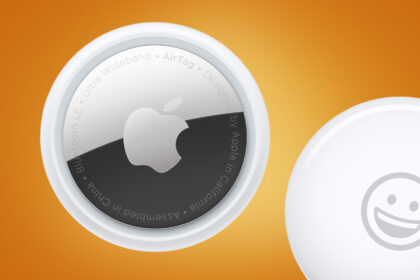 Two Apple AirTags on an orange background