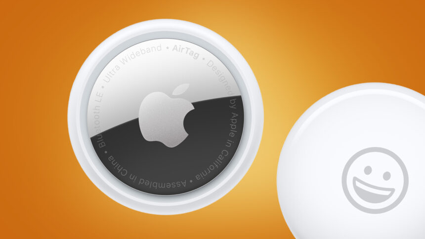 Two Apple AirTags on an orange background