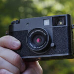 Fujifilm X half camera in the hand at golden hour