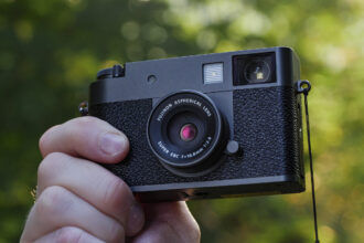 Fujifilm X half camera in the hand at golden hour