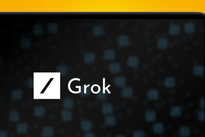A laptop on an orange background showing the xAI Grok logo