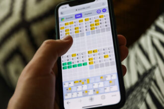 Quordle on a smartphone held in a hand