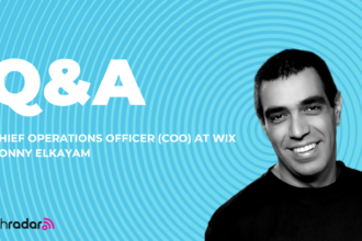 headshot of Ronny Elkayam COO of Wix against a spiral backdrop in blue