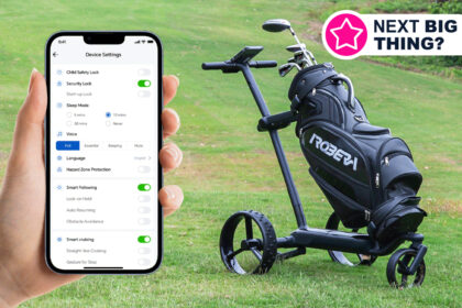 A hand holding a phone next to an AI-powered golf cart