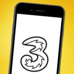 A phone on an orange background showing the Three mobile logo