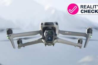 The DJI Air 3S drone flying with some mountains in the background