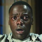 Daniel Kaluuya sits open-mouthed staring into the camera with tears running down his face