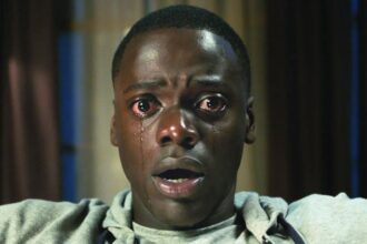 Daniel Kaluuya sits open-mouthed staring into the camera with tears running down his face