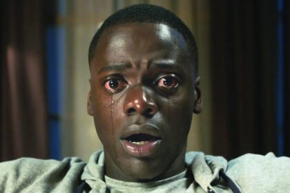 Daniel Kaluuya sits open-mouthed staring into the camera with tears running down his face