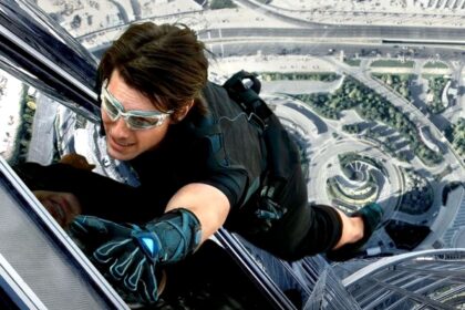Tom Cruise wears eye goggles and climbing gear while scaling the Burj Khalifa