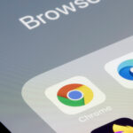 Google Chrome app is seen on an iPhone next to Edge and other web browser apps. Microsoft is using new prompts in Edge to try and stop users from downloading Chrome.