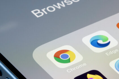 Google Chrome app is seen on an iPhone next to Edge and other web browser apps. Microsoft is using new prompts in Edge to try and stop users from downloading Chrome.