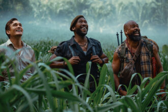 Three member of Zora's team smiling as they look at an off-screen dinosaur in Jurassic World Rebirth