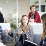 Employees sat around together discussing business issues.