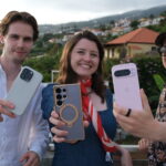 Three people holding the best AI phones - Samsung Galaxy S25 Ultra, iPhone 16 Pro, Google Pixel 9 Pro