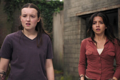 Ellie and Dina standing and looking shocked in The Last of Us season 2 episode 4