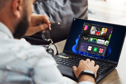 Back view of a man using a laptop with Windows 11's Microsoft Store app open