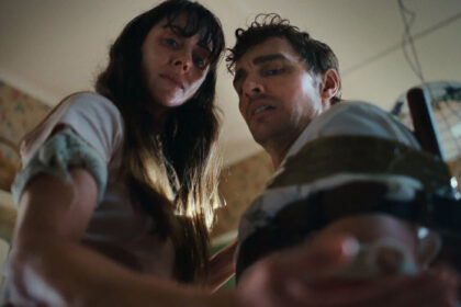 A couple looking down at one of their hands in Neon body horror movie Together
