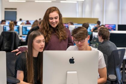 Students using Apple devices in a classroom.