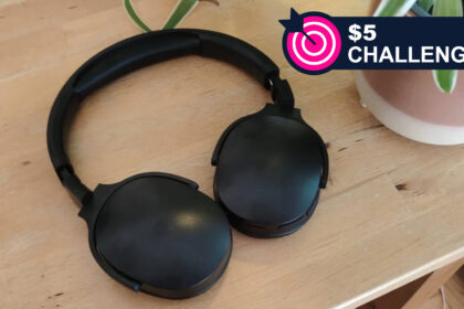 The Generic P2961 headphones in black on a wooden table, with TR's $5 Challenge badge