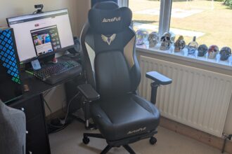 The AutoFull M6 Ultra gaming chair pictured in front of a desk with a gaming PC setup.