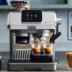 De'Longhi La Specialista Touch coffee machine on a counter, surrounded by full coffee-based drinks.