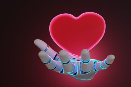 Robotic arm having a glowing red heart floating above its palm on dark background. Illustration of the concept of emotion artificial intelligence and digital feeling