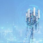 Telecommunication tower or Mobile phone tower with 5G cellular network . Global connection and internet network concept.on city background.