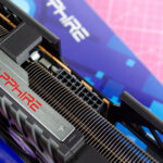 An AMD Radeon RX 9070 XT made by Sapphire on a table with its retail packaging