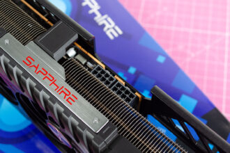 An AMD Radeon RX 9070 XT made by Sapphire on a table with its retail packaging