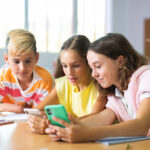 Kids with cellphones in classroom