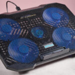 The Aimuzi F2 Plus laptop cooling pad at a 3/4s angle in front of a pink background.