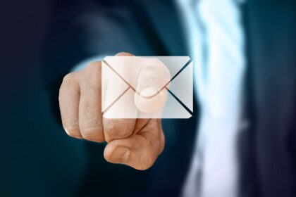 Close up of a person touching an email icon.