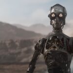 A protocol droid stands in a desert