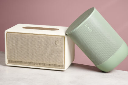 The Sonos Move 2 leaning at a 45-degree angle against the Edifier ES300 in front of a pink background.