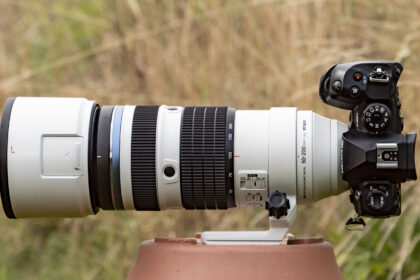 OM System M.Zuiko Digital ED 50-200mm F2.8 IS Pro lens attached to an OM-1 II, outdoors with long grass in the background