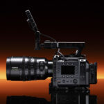 Fujifilm GFX Eterna 55 cinema camera with 32-90mm lens attached, punchy orange strip light in the background