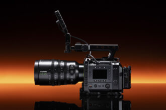 Fujifilm GFX Eterna 55 cinema camera with 32-90mm lens attached, punchy orange strip light in the background