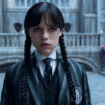 Jenna Ortega's Wednesday Addams standing in Nevermore Academy's courtyard in Wednesday season 2
