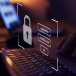 A cybersecurity icon projecting from a laptop screen.