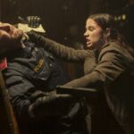 Eve (Ana de Armas) fighting an armed police officer in Ballerina